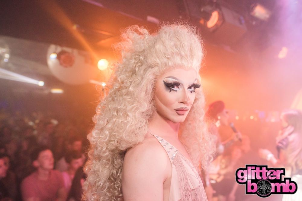 A group of friends and a drag performer taking a selfie together at a Glitterbomb night
